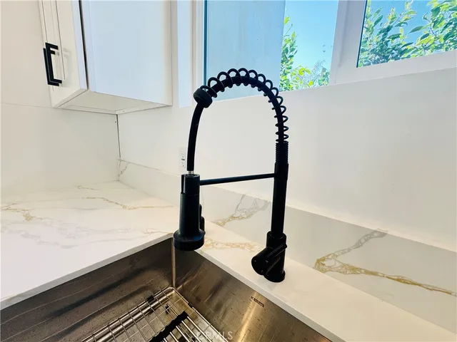 a kitchen with stainless steel appliances a stove a sink and a microwave