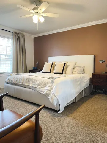 a bedroom with bed and window