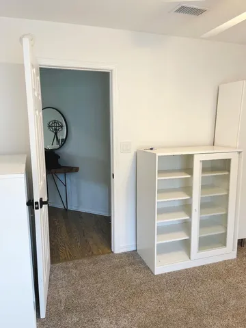 a view of room with wooden floor