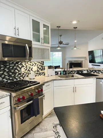 a kitchen with stainless steel appliances a stove a microwave and cabinets