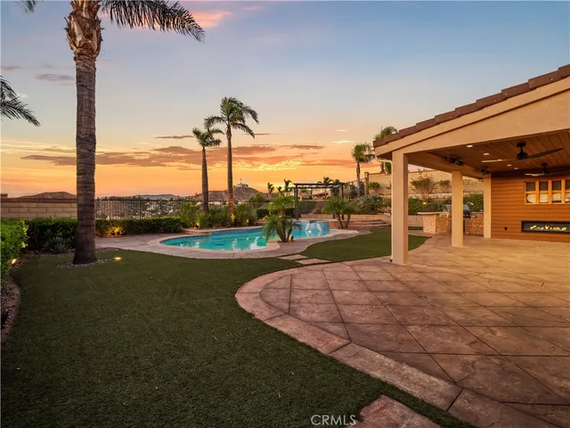a view of a house with a yard and street