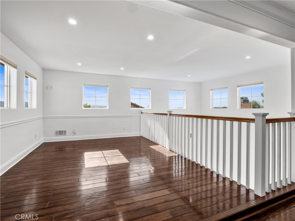 29461 Sequoia Road Canyon Country, CA 91387 - Photo 16 of 51 a view of empty room with wooden floor and fan