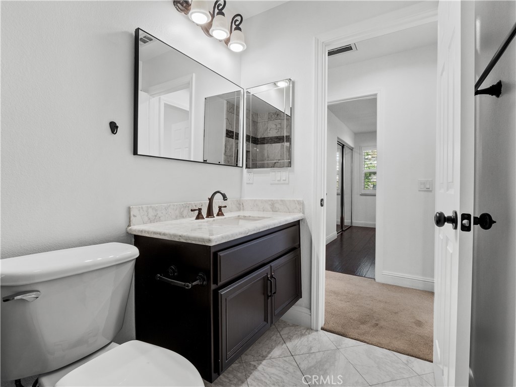 29461 Sequoia Road Canyon Country, CA 91387 - Photo 27 of 51 a bathroom with a toilet sink and mirror