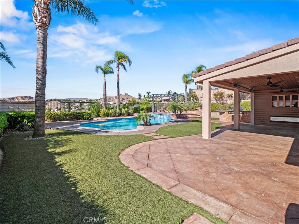 29461 Sequoia Road Canyon Country, CA 91387 - Photo 32 of 51 a view of a house with a swimming pool and a yard