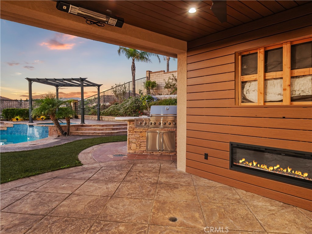 29461 Sequoia Road Canyon Country, CA 91387 - Photo 38 of 51 a view of a patio with table and chairs a barbeque with wooden fence