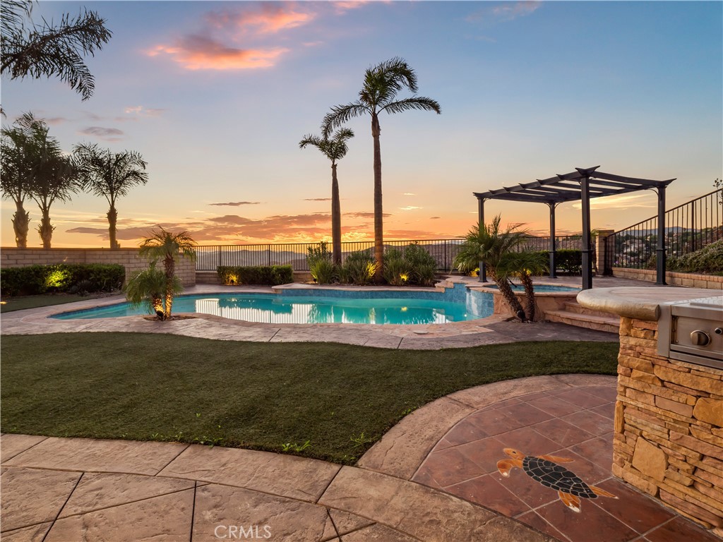29461 Sequoia Road Canyon Country, CA 91387 - Photo 44 of 51 a view of a swimming pool with a lawn chairs under palm trees