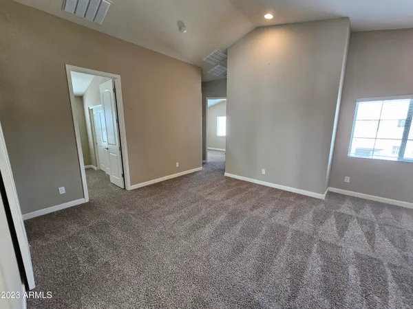 an empty room with windows and closet