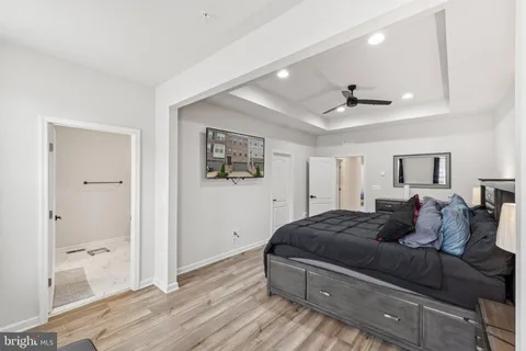 a living room with a bed and glass door