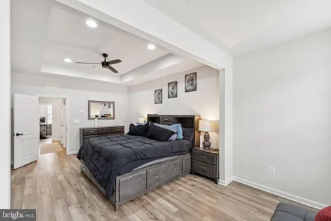 a bedroom with a large bed and a chandelier