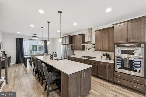 a kitchen with sink stove and cabinets