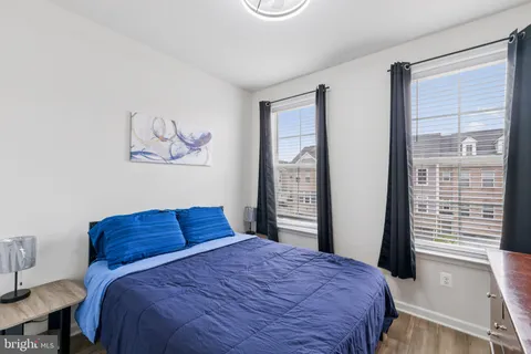 a bedroom with a bed and a large window