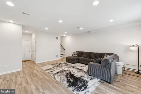 a living room with furniture and a book shelf