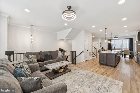 a living room with furniture and kitchen view