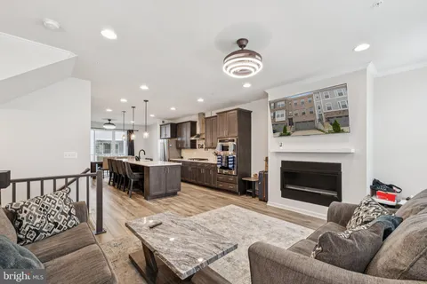 a living room with furniture kitchen and a fireplace
