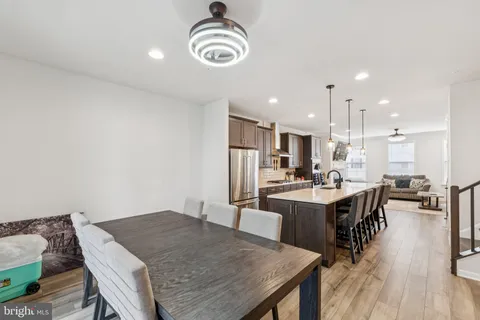 a large kitchen with a table and chairs