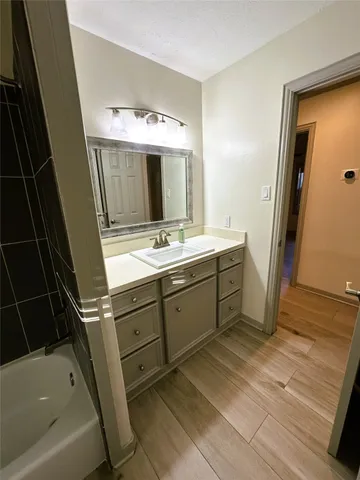 a bathroom with a sink a mirror and a bathtub