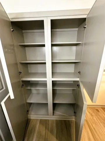 a view of walk in closet with empty racks