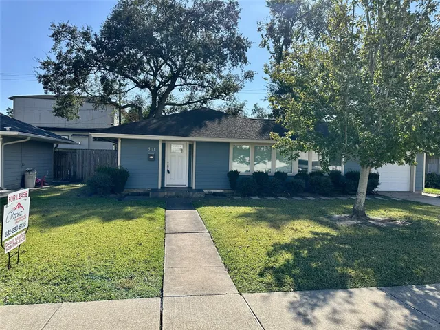 a view of a house with swimming pool and a yard
