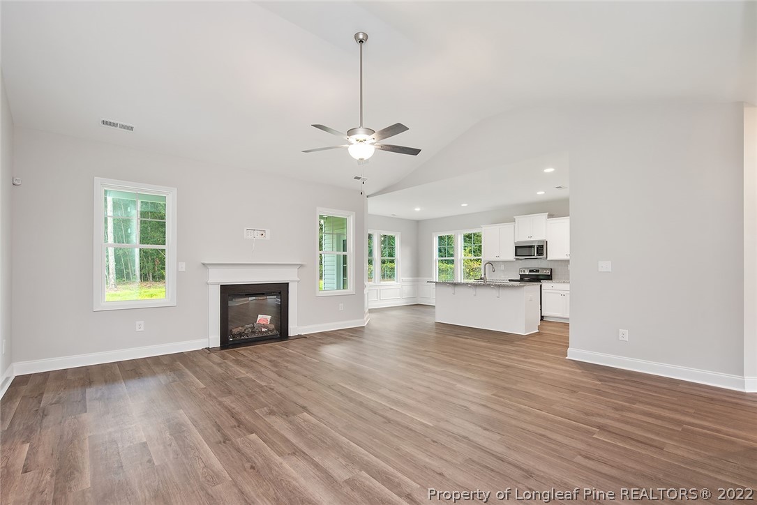 7668 Rufus Johnson Road Fayetteville, NC 28306 - Photo 5 of 29 a view of an empty room with a fireplace and a window