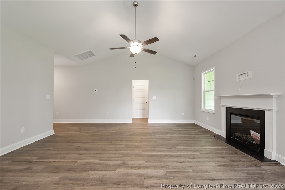 7668 Rufus Johnson Road Fayetteville, NC 28306 - Photo 8 of 29 a view of an empty room with a fireplace and a window