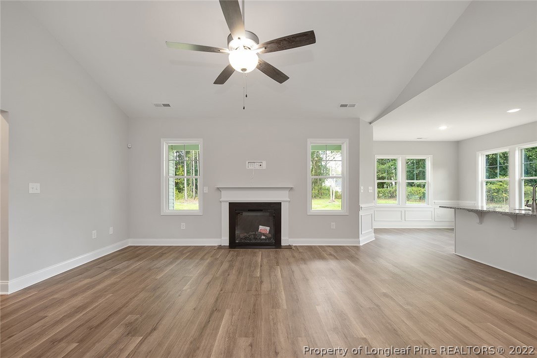 7668 Rufus Johnson Road Fayetteville, NC 28306 - Photo 9 of 29 a view of an empty room with a window and wooden floor