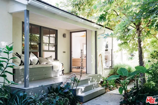 a living room filled with furniture and flowers