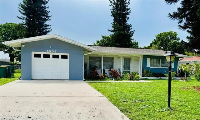 a front view of house with yard and green space