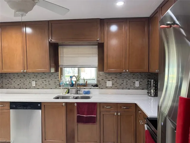a kitchen with stainless steel appliances granite countertop a sink and cabinets