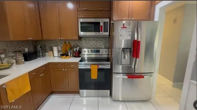 a kitchen with a refrigerator and a sink