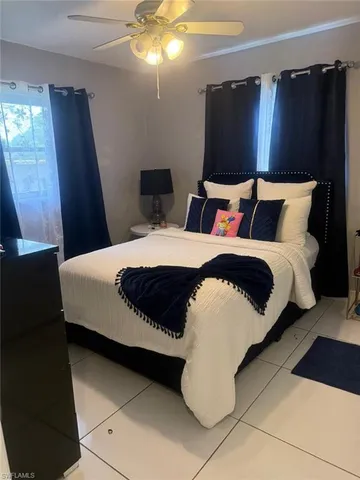 a bedroom with bed and wooden floor