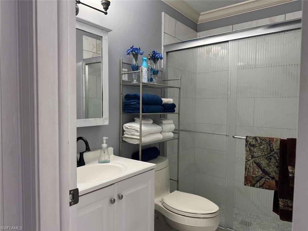 4454 19th Place Southwest Naples, FL 34116 - Photo 20 of 30 a white toilet sitting next to a bathroom sink