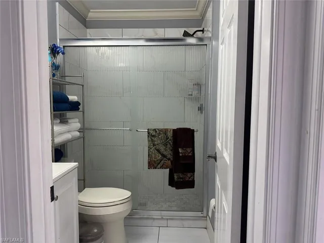 a bathroom with a toilet and a shower