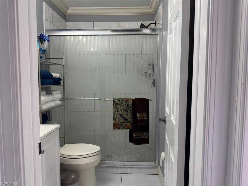 4454 19th Place Southwest Naples, FL 34116 - Photo 21 of 30 a bathroom with a toilet and a shower