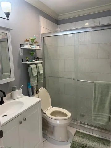 a bathroom with a toilet a sink and shower