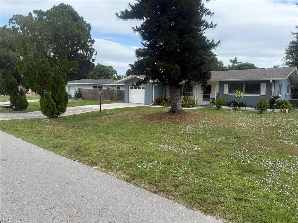 4454 19th Place Southwest Naples, FL 34116 - Photo 26 of 30 front view of a house with a yard