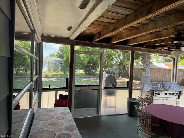 a view of a porch with furniture and floor to ceiling window
