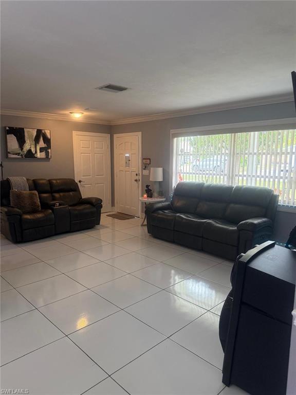 4454 19th Place Southwest Naples, FL 34116 - Photo 7 of 30 a living room with furniture and a window