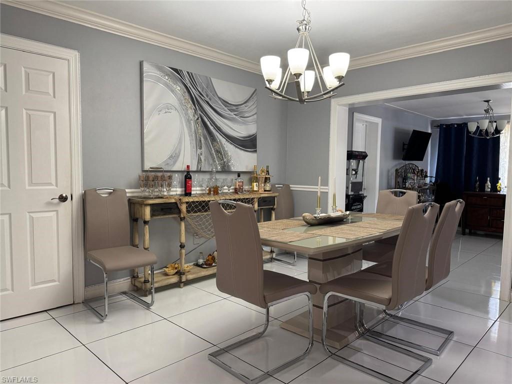 4454 19th Place Southwest Naples, FL 34116 - Photo 9 of 30 a view of a dining room with furniture