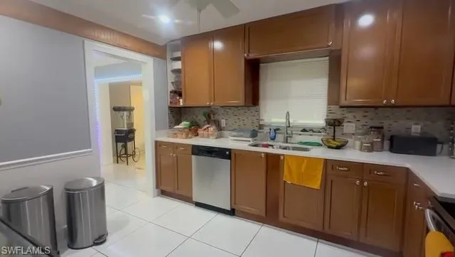 a kitchen with sink a stove and cabinets