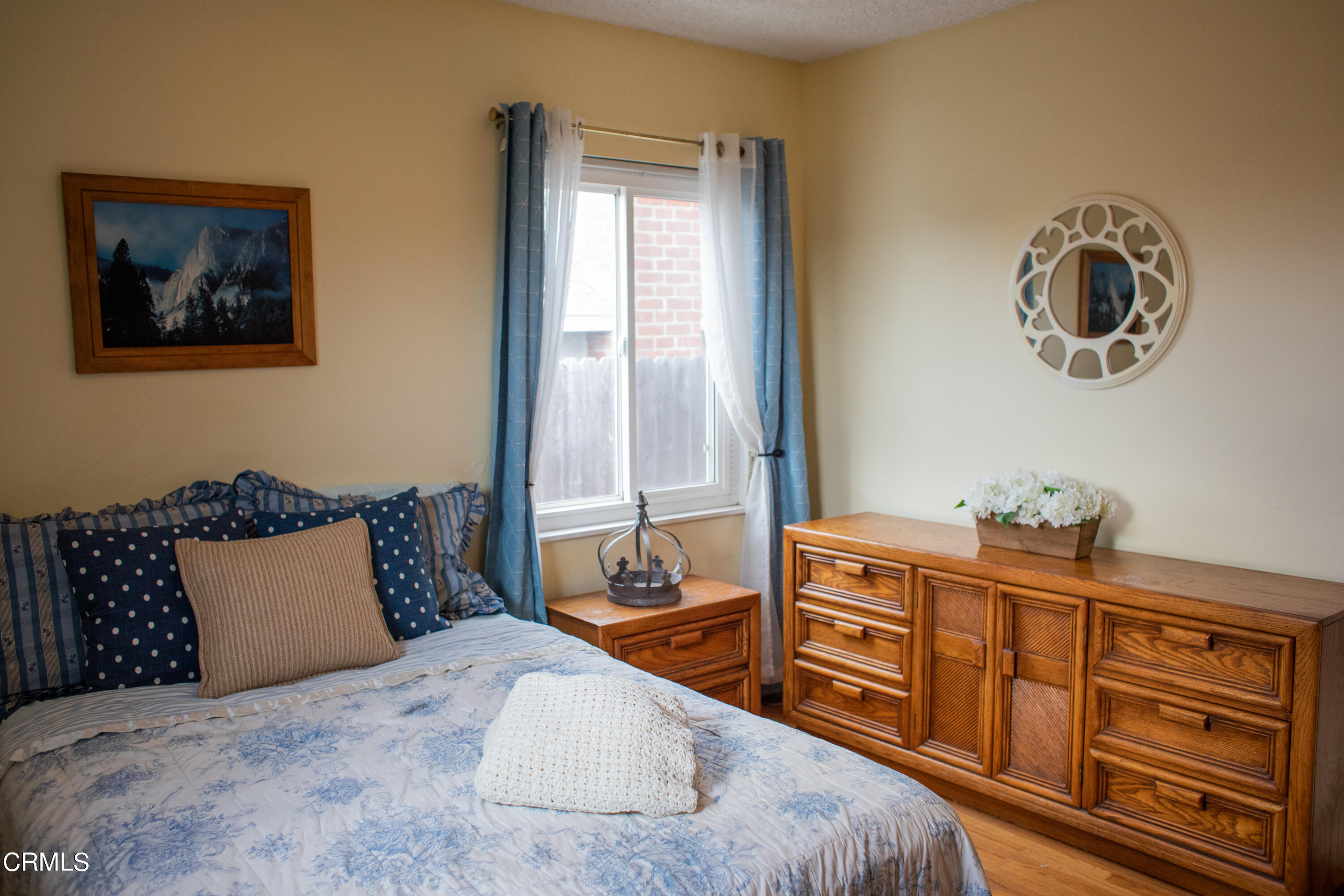117 Kenneth Street Camarillo, CA 93010 - Photo 14 of 24 a bedroom with a bed and wooden cabinets