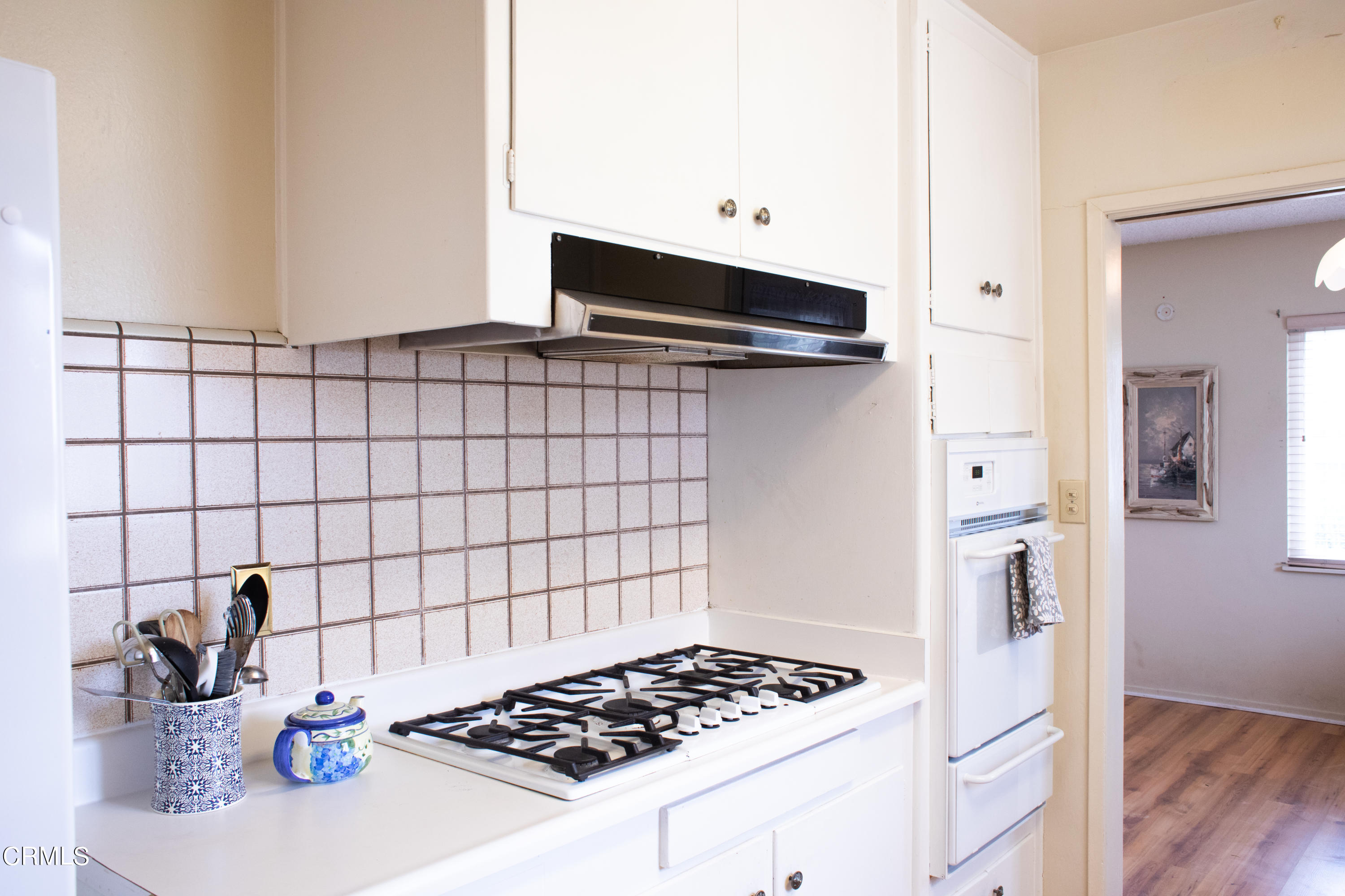 117 Kenneth Street Camarillo, CA 93010 - Photo 10 of 24 a kitchen with a sink and a stove top oven