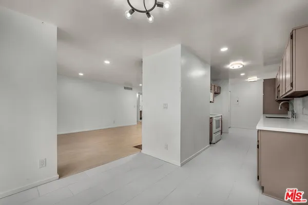a view of a kitchen with a sink and a refrigerator