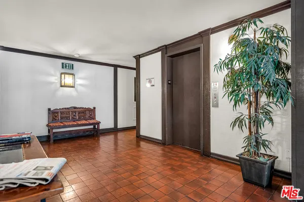 a bedroom with furniture and a potted plant