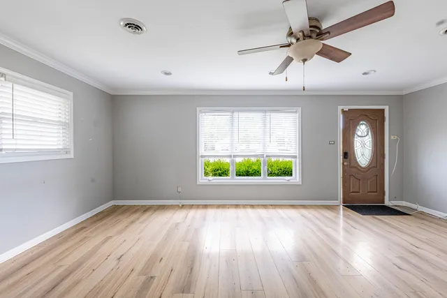 wooden floor in an empty room with a window