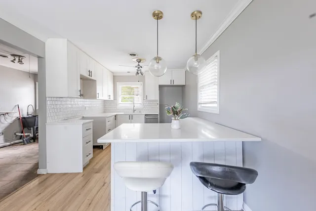 a view of kitchen and sink with wooden floor