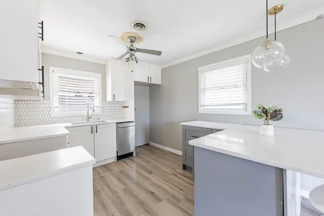 a kitchen with a sink stove and microwave