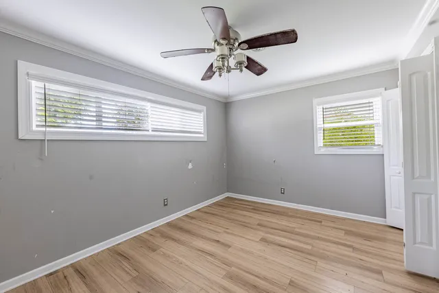 a view of room with hardwood floor and ceiling fan