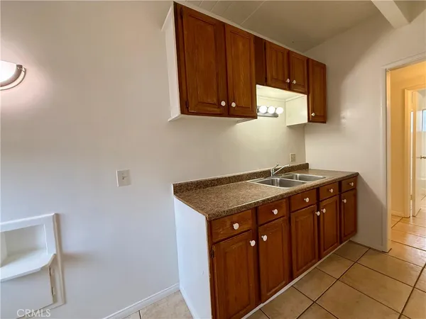 a spacious bathroom with a granite countertop sink and a toilet