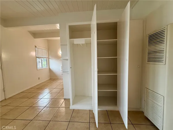 a view of an empty room & window