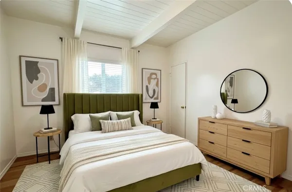 a bedroom with a bed and a dresser
